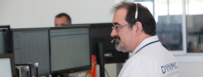 Dynamic Business Technologies' IT support technician on headset helping a caller